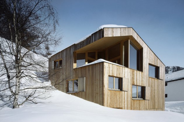 Una casa de madera en la nieve, construcción de casas de madera. Un gran trozo de madera tallado para configurar esta casa en la montaña. 